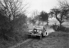 Lord Avebury's Ford V8 competing in the Sunbac Colmore Trial, Gloucestershire, 1934. Artist: Bill Brunell