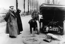 Lord Northcliffe's chauffeur changing a tyre, (c1908?)
