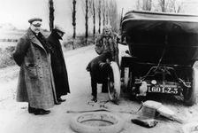 Lord Northcliffe's chauffeur changing a tyre, (c1908?)