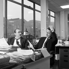 Lost order? two salesmen try to sort out the orders over a cigarette, 1967. Artist: Michael Walters