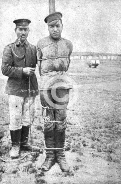 'La peine du poteau; au poteau: deux soldats russes au camp de Lamsdorf, en Silisie', 1917. Creator: Unknown.