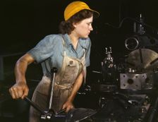 Lathe operator machining parts...Consolidated Aircraft Corporation plant, Fort Worth, TX, 1942. Creator: Howard Hollem
