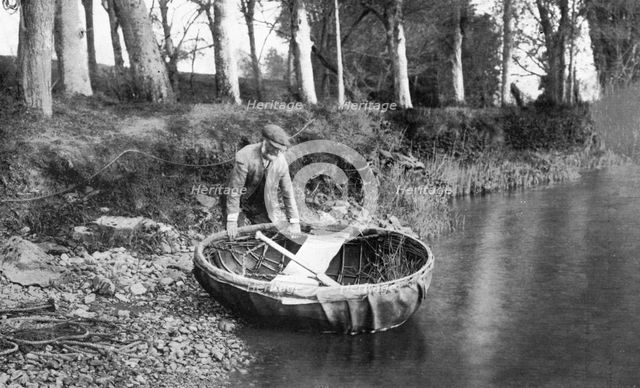 Launching a coracle on the River Boyne, County Meath, Ireland, 1924-1926. Artist: WA Green