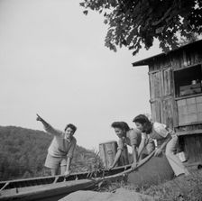 Launching a canoe at Camp Gaylord White, Arden, New York, 1943. Creator: Gordon Parks