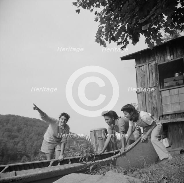 Launching a canoe at Camp Gaylord White, Arden, New York, 1943. Creator: Gordon Parks.