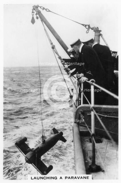 Launching a paravane from the battleship HMS 'Rodney', 1937. Artist: Unknown
