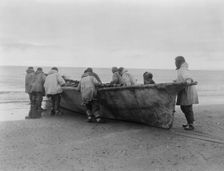 Launching the whale boat-Cape Prince of Wales, c1929. Creator: Edward Sheriff Curtis