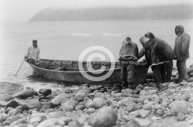 Launching the boat-Little Diomede Island, c1928. Creator: Edward Sheriff Curtis.