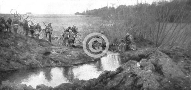 'L'avance Francaise; La traversee d'un ruisseau par un groupe cycliste: il existait la un petit pont Creator: Unknown.