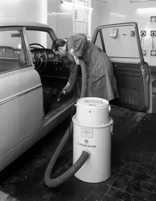 Laycock Vacacar vacuum cleaner in use at an Esso garage, Sheffield, South Yorkshire, 1965. Creator: Michael Walters