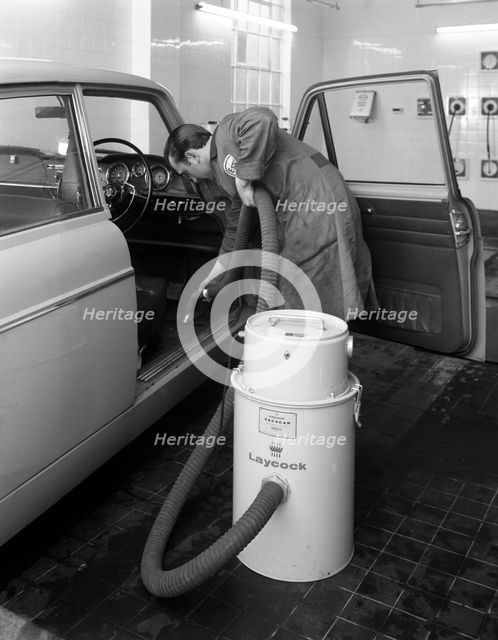 Laycock Vacacar vacuum cleaner in use at an Esso garage, Sheffield, South Yorkshire, 1965. Artist: Michael Walters