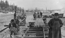 Laying first rails of new U.S. railroad at Ship Creek, between c1900 and c1930. Creator: Unknown