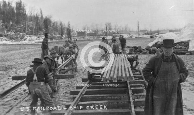 Laying first rails of new U.S. railroad at Ship Creek, between c1900 and c1930. Creator: Unknown.