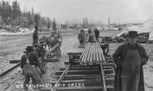 Laying first rails of new U.S. railroad at Ship Creek, between c1900 and c1930. Creator: Unknown