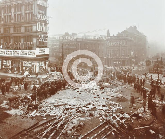 Laying tramlines at the junction of Whitechapel High Street and Commercial Road, London, 1907. Artist: Unknown.
