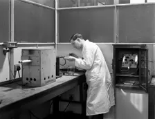 Lab tachnician using a table top test furnace, Sheffield, South Yorkshire, 1962. Creator: Michael Walters