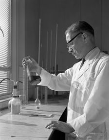 Lab technician at a steelworks in Sheffield, South Yorkshire, 1963. Creator: Michael Walters