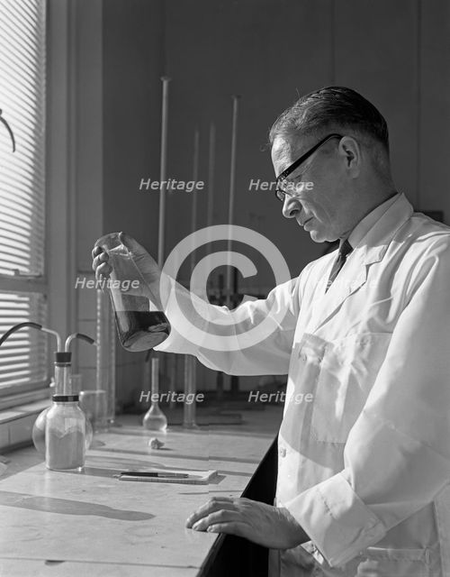 Lab technician at a steelworks in Sheffield, South Yorkshire, 1963. Creator: Michael Walters.