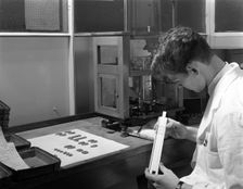 Lab technician with a slide rule, Edgar Allen's steel foundry, Sheffield, South Yorkshire, 1962. Creator: Michael Walters