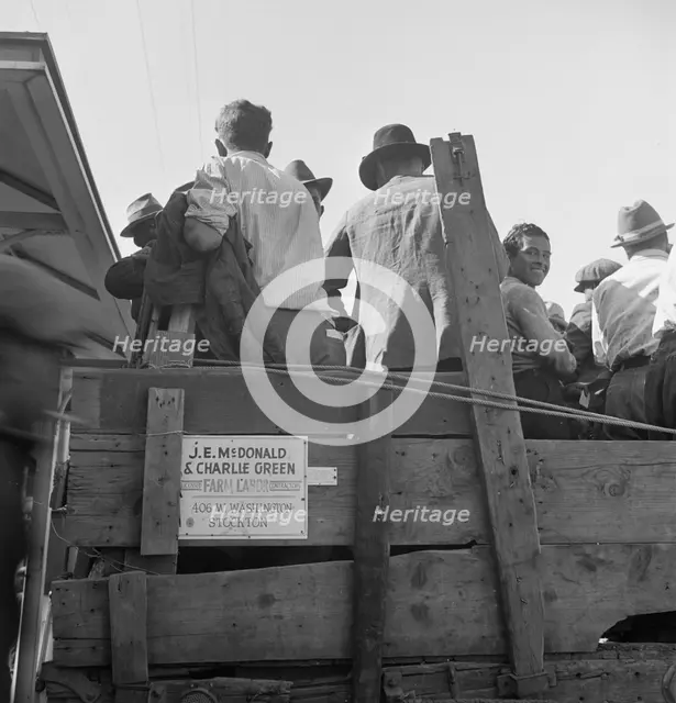 Labor contractor's truck with gang of pea pickers pulled up for gas, Westley, California, 1939. Creator: Dorothea Lange.