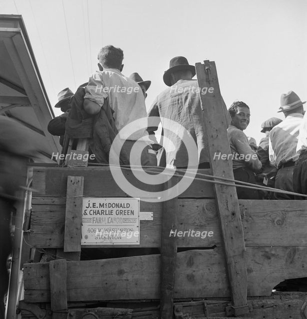 Labor contractor's truck with gang of pea pickers pulled up for gas, Westley, California, 1939. Creator: Dorothea Lange.