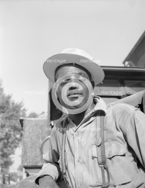Laborer listening to instructions being given by a section foreman, Washington, D.C, 1942. Creator: Gordon Parks.