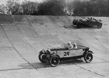 Lagonda and Alfa Romeo on the banking at the JCC Double Twelve Race, Brooklands, Surrey, 1929. Artist: Bill Brunell