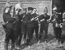 L'aide Francaise a la Belgique; A l'ecart, l'etat-major de la brigade etudie la carte 1914. Creator: Unknown