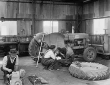 Laing workers carrying out maintenance work on the a Fordson Major Diesel Tractor, 22/07/1959. Creator: John Laing plc