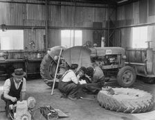 Laing workers carrying out maintenance work on the a Fordson Major Diesel Tractor, 22/07/1959. Creator: John Laing plc