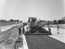 Laing workers operating a paver machine, London to Yorkshire Motorway (M1, 22/07/1959. Creator: John Laing plc