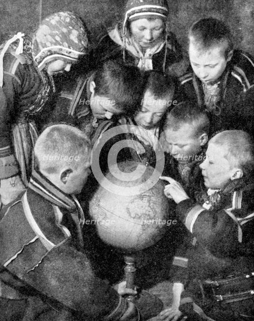 Lapp children looking at a globe, 1936. Artist: Unknown