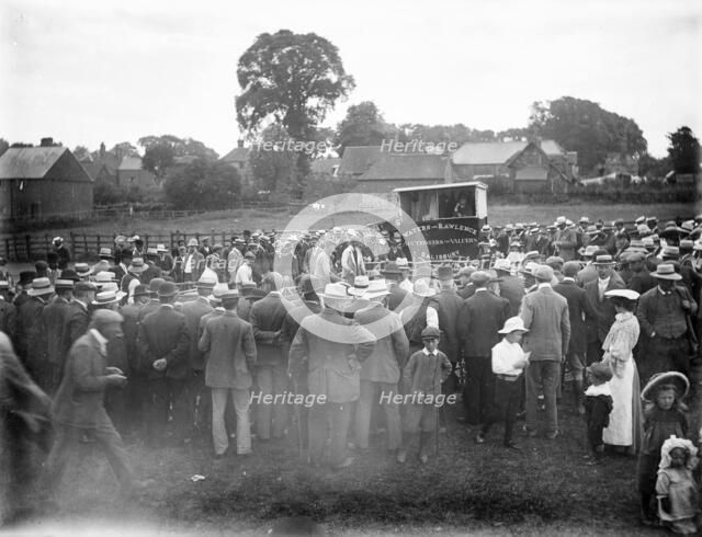 Large crowd gathered round a pen during the auction of rams, East Ilsley, West Berkshire, 1860-1922. Creator: Henry Taunt.