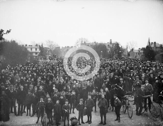 Large crowd on the bridge on May Morning to hear the college choir, Magdalen Bridge, Oxford, 1895. Creator: Henry Taunt.