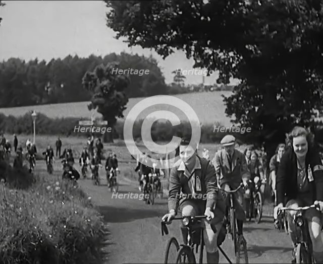 Large Group of Civilians Riding Bicycles Through Country Lanes, 1931. Creator: British Pathe Ltd.