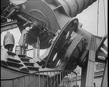 Large Telescope Being Turned by Two Civilians, 1931. Creator: British Pathe Ltd