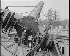 Large Telescope Being Turned by Two Civilians, 1931. Creator: British Pathe Ltd