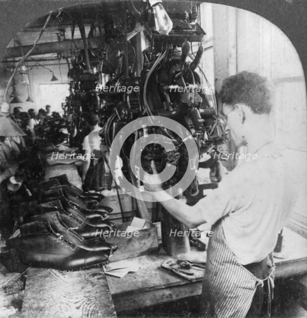 Lasting machine shaping shoes in shoe factory, Lynn, Massachusetts, USA, early 20th century(?). Artist: Keystone View Company