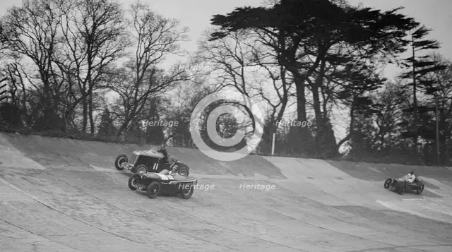 Lea-Francis Hyper of AS Llewellyn and Amilcar of Major A Gardner, BARC meeting, Brooklands, 1930. Artist: Bill Brunell.