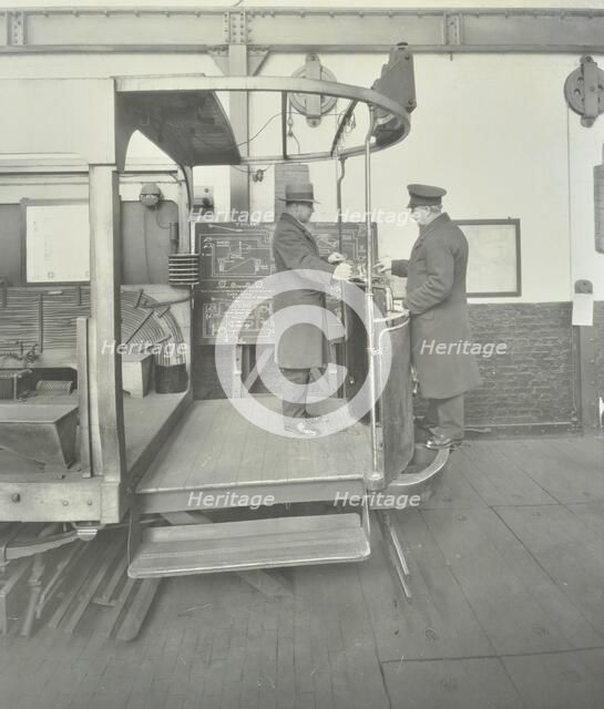 Learner-driver under instruction in a mock-up of tram car cab, London, 1932. Artist: Unknown.