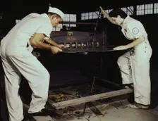 Learning to work a cutting machine, these two NYA employees...Corpus Christi, Texas, 1942. Creator: Howard Hollem
