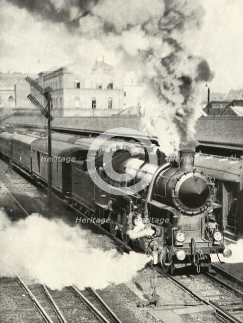 'Leaving Budapest. An express train departs from the Central Station', 1935-36. Creator: Unknown.