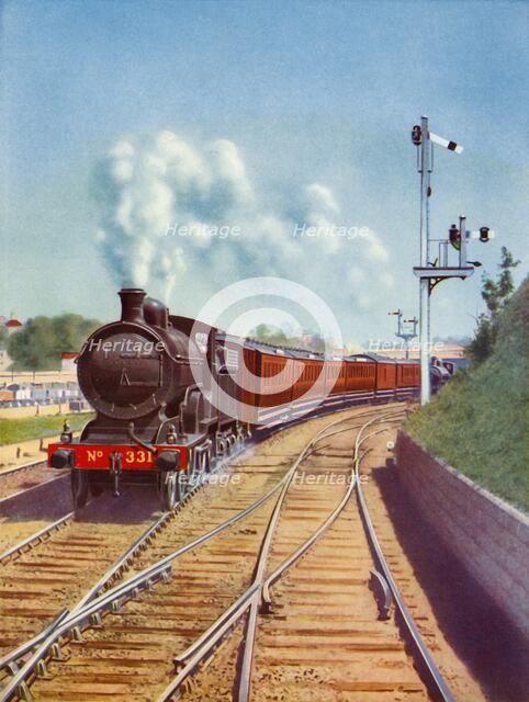 'Leaving Dublin. Great Southern Railways train, hauled by a 4-4-0 passenger express', 1935. Creator: Unknown.