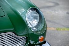 Left front headlight of a 1961 Aston Martin DB4 GT previously owned by Donald Campbell. Creator: Unknown