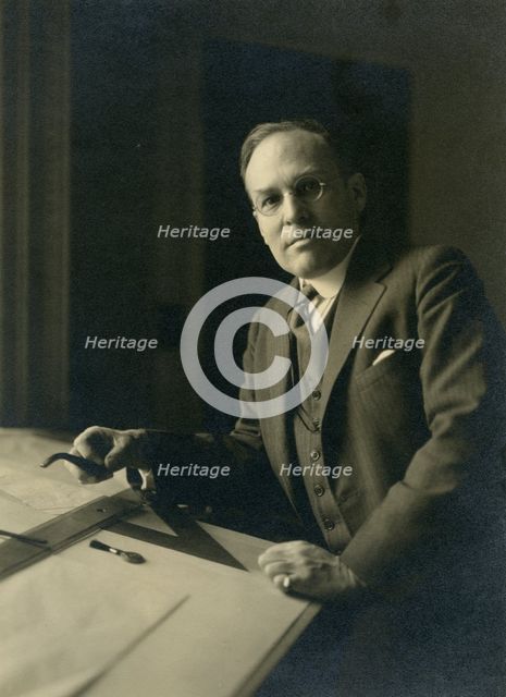 Leicester B. Holland, Chief of Fine Arts Division, Library of Congress posed...table, (1930?). Creator: Frances Benjamin Johnston.