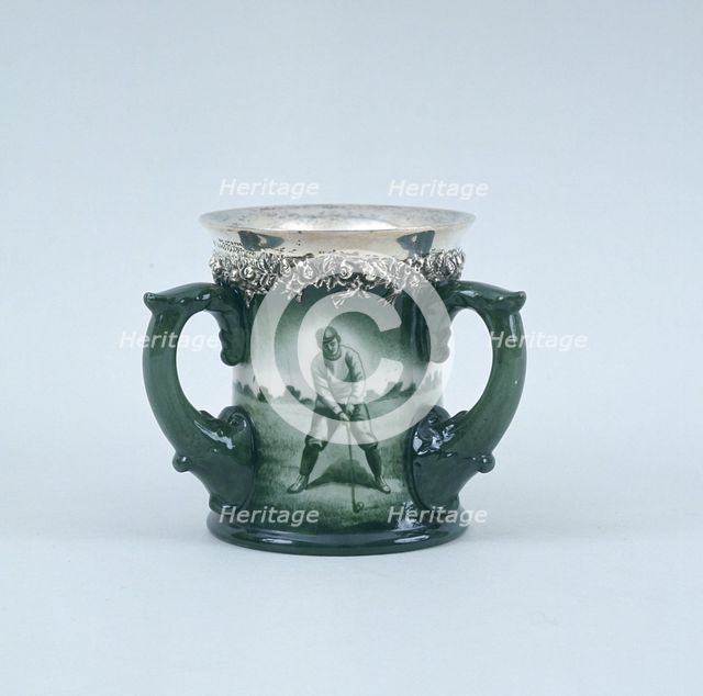 Lenox hand-painted three-handled toasting mug with silver rim, c1902. Creator: Unknown.