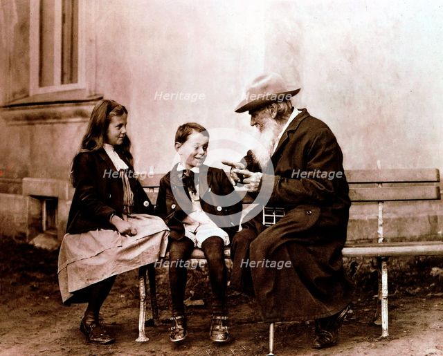 Leo Tolstoy, Russian writer, philosopher and mystic, telling his grandchildren a story, c1890-1910. Artist: Unknown
