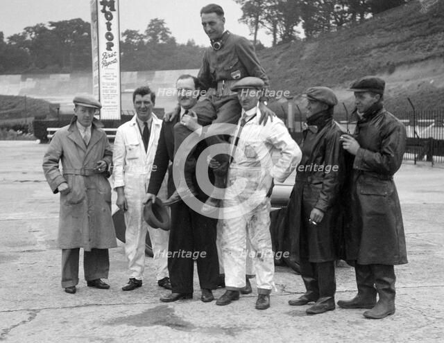Leon Cushman being carried aloft after making a successful speed record attempt, Brooklands, 1931. Artist: Bill Brunell.