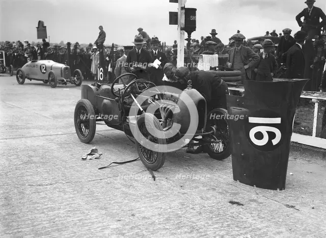 Leon Cushman working on his Bugatti Brescia at the JCC 200 Mile Race, Brooklands, Surrey, 1922. Artist: Bill Brunell.