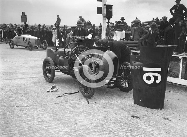 Leon Cushman working on his Bugatti Brescia at the JCC 200 Mile Race, Brooklands, Surrey, 1922. Artist: Bill Brunell.